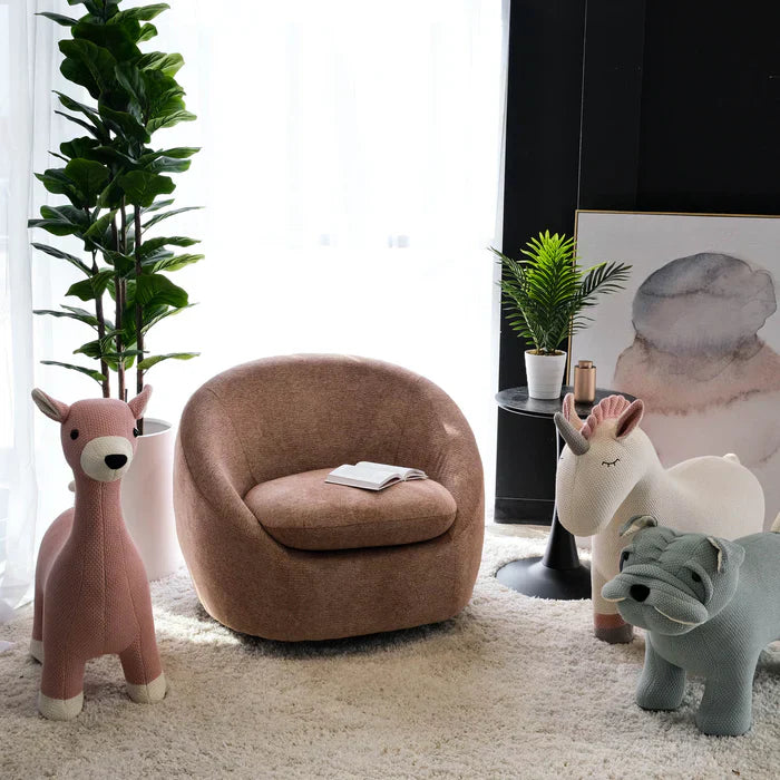 Bright room with plush beige carpet and a Savona Rouge Barrel accent chair in a soft rose suede-look material surrounded by chic decor